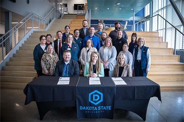 DSU faculty and staff and LATC staff pose for a photo at the articulation agreement signing.